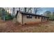 Charming brick home showcasing backyard with tree coverage and gate at 868 Maxey Hill Ct, Stone Mountain, GA 30083