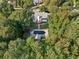Aerial view featuring home's backyard pool, a storage shed, and treed surroundings at 9435 Grande Dr, Winston, GA 30187