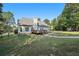 The backyard view showcases a deck and a well-maintained lawn, complemented by mature trees and fenced yard at 9435 Grande Dr, Winston, GA 30187