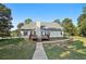 A spacious backyard featuring a wooden deck and a well-maintained lawn, complemented by mature trees and fenced yard at 9435 Grande Dr, Winston, GA 30187
