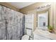 A full bathroom features a vanity with a white sink and seashell-themed shower curtain at 9435 Grande Dr, Winston, GA 30187