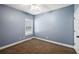 Carpeted bedroom featuring a window and a ceiling fan at 9435 Grande Dr, Winston, GA 30187