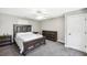 A cozy bedroom features carpet flooring, ceiling fan, and is furnished with a dark wood bedroom set at 9435 Grande Dr, Winston, GA 30187