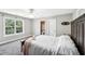 A carpeted bedroom has an ensuite bathroom and large window at 9435 Grande Dr, Winston, GA 30187