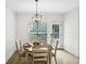 Cozy dining area with natural light and a modern chandelier at 9435 Grande Dr, Winston, GA 30187