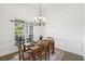 Formal dining room featuring hardwood floors, large windows, and decorative chandelier at 9435 Grande Dr, Winston, GA 30187