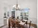 Formal dining room featuring hardwood floors, large windows, and a decorative chandelier at 9435 Grande Dr, Winston, GA 30187