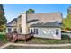 Back of the house with deck, siding, chimney and big yard at 9435 Grande Dr, Winston, GA 30187