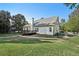 The backyard view showcases a deck and a well-maintained lawn, complemented by mature trees and fenced yard at 9435 Grande Dr, Winston, GA 30187