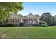 Charming brick home features a columned front porch, manicured landscaping, and inviting curb appeal at 9435 Grande Dr, Winston, GA 30187