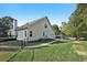 Rear view of a home with a well-maintained lawn, deck, and a fenced yard, perfect for privacy and outdoor enjoyment at 9435 Grande Dr, Winston, GA 30187
