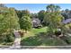Expansive front lawn and mature trees surround this inviting home with a charming, classic facade at 9435 Grande Dr, Winston, GA 30187