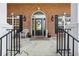 Welcoming front porch with brick facade, a decorative door, and outdoor seating at 9435 Grande Dr, Winston, GA 30187