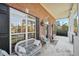 Inviting front porch with brick facade, large windows, and comfortable seating at 9435 Grande Dr, Winston, GA 30187