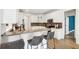 Updated eat-in kitchen featuring white cabinets, stainless steel appliances, and a breakfast bar with gray bar stools at 9435 Grande Dr, Winston, GA 30187