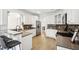 Bright kitchen with white cabinets, a stainless steel refrigerator, and bar seating at 9435 Grande Dr, Winston, GA 30187