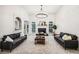 Bright living room with fireplace, modern chandelier and two grey sofas at 9435 Grande Dr, Winston, GA 30187