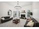 Spacious living room featuring a fireplace, gray sofas, and modern lighting at 9435 Grande Dr, Winston, GA 30187