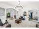 Bright living room with an open floor plan, archways, and contemporary lighting at 9435 Grande Dr, Winston, GA 30187