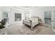 Bright main bedroom with trey ceiling, large windows, and wrought iron bed frame on neutral rug at 9435 Grande Dr, Winston, GA 30187