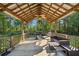 Wooden outdoor patio features ceiling fans, seating area, grill and nature views at 9435 Grande Dr, Winston, GA 30187