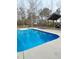 Backyard pool view featuring a fenced-in area, lounge chairs and an outdoor kitchen area at 9435 Grande Dr, Winston, GA 30187