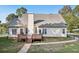 The home's rear exterior features a charming deck and well-maintained backyard at 9435 Grande Dr, Winston, GA 30187