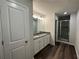 Bathroom featuring white cabinets, granite countertops, dual sinks, and a glass-enclosed shower at 45 Heyman Dr, Covington, GA 30016