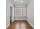 Bright, empty bedroom with hardwood floors and a window overlooking the neighborhood at 733 Frederica Ne St # 7, Atlanta, GA 30306