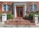 Apartment entrance with brick steps, red doors, and a white pillar framed entryway at 733 Frederica Ne St # 7, Atlanta, GA 30306