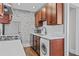 Galley kitchen with stainless steel appliances, stylish exposed brick, and washer/dryer at 733 Frederica Ne St # 7, Atlanta, GA 30306