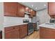 Well-equipped kitchen with stainless steel appliances, dark wood cabinets, and a stylish brick wall at 733 Frederica Ne St # 7, Atlanta, GA 30306