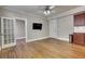 Bright living room with hardwood floors, ceiling fan and tv, leads to another room at 733 Frederica Ne St # 7, Atlanta, GA 30306