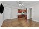 Open living room with hardwood floors and kitchen with stainless steel appliances at 733 Frederica Ne St # 7, Atlanta, GA 30306