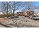 View of a spacious parking lot surrounded by trees and well-maintained apartment buildings at 733 Frederica Ne St # 7, Atlanta, GA 30306