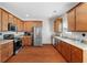 Modern kitchen with stainless steel appliances, wooden cabinets, and countertops at 8584 Tara Place Dr, Jonesboro, GA 30236