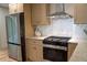 Modern kitchen featuring stainless steel appliances, a gas range, and marble hexagon backsplash at 1395 Winburn Dr, East Point, GA 30344