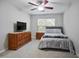 Neutral bedroom featuring a full bed, ceiling fan and large window for natural light at 394 Teal Ct, Roswell, GA 30076