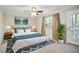 Serene bedroom featuring a ceiling fan, a comfortable bed, and balcony access at 394 Teal Ct, Roswell, GA 30076
