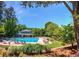 Large community pool surrounded by lush landscaping and comfortable lounge chairs at 394 Teal Ct, Roswell, GA 30076