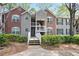 Charming condo building with brick and siding exterior, accented by well-maintained landscaping at 394 Teal Ct, Roswell, GA 30076