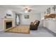 Cozy living room with a fireplace, a plush sofa, and a comfortable atmosphere at 394 Teal Ct, Roswell, GA 30076
