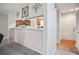Open living area with a breakfast bar, hardwood floors, and modern decor at 394 Teal Ct, Roswell, GA 30076