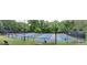 Enjoy these community pickleball courts surrounded by mature trees, with ample seating, and professional netting at 394 Teal Ct, Roswell, GA 30076
