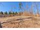 Backyard fence with steps leading up a landscaped hill at 4152 Woodward Mill Rd, Sugar Hill, GA 30518