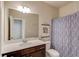 Bright bathroom featuring a white vanity top, dark wood cabinets and modern fixtures at 4152 Woodward Mill Rd, Sugar Hill, GA 30518