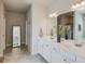 Bathroom boasts a double vanity with a large mirror, tile floor and ample counter space at 4152 Woodward Mill Rd, Sugar Hill, GA 30518