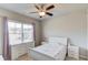 Cozy bedroom with large window, white furniture, ceiling fan and light purple curtains at 4152 Woodward Mill Rd, Sugar Hill, GA 30518