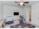 Bright bedroom features TV, work area and seating for playroom or flexible additional bedroom at 4152 Woodward Mill Rd, Sugar Hill, GA 30518