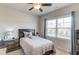 Cozy bedroom with a ceiling fan, window, and side table with drawers at 4152 Woodward Mill Rd, Sugar Hill, GA 30518